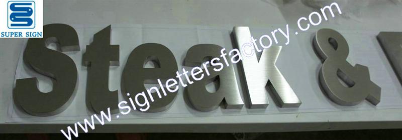 Built-up brushed stainless steel sign letters