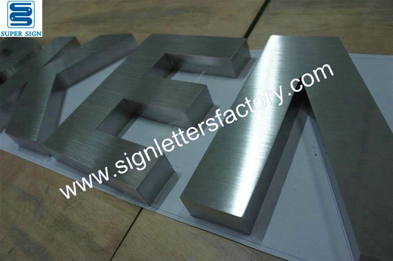 fabricated brushed stainless steel shop signage